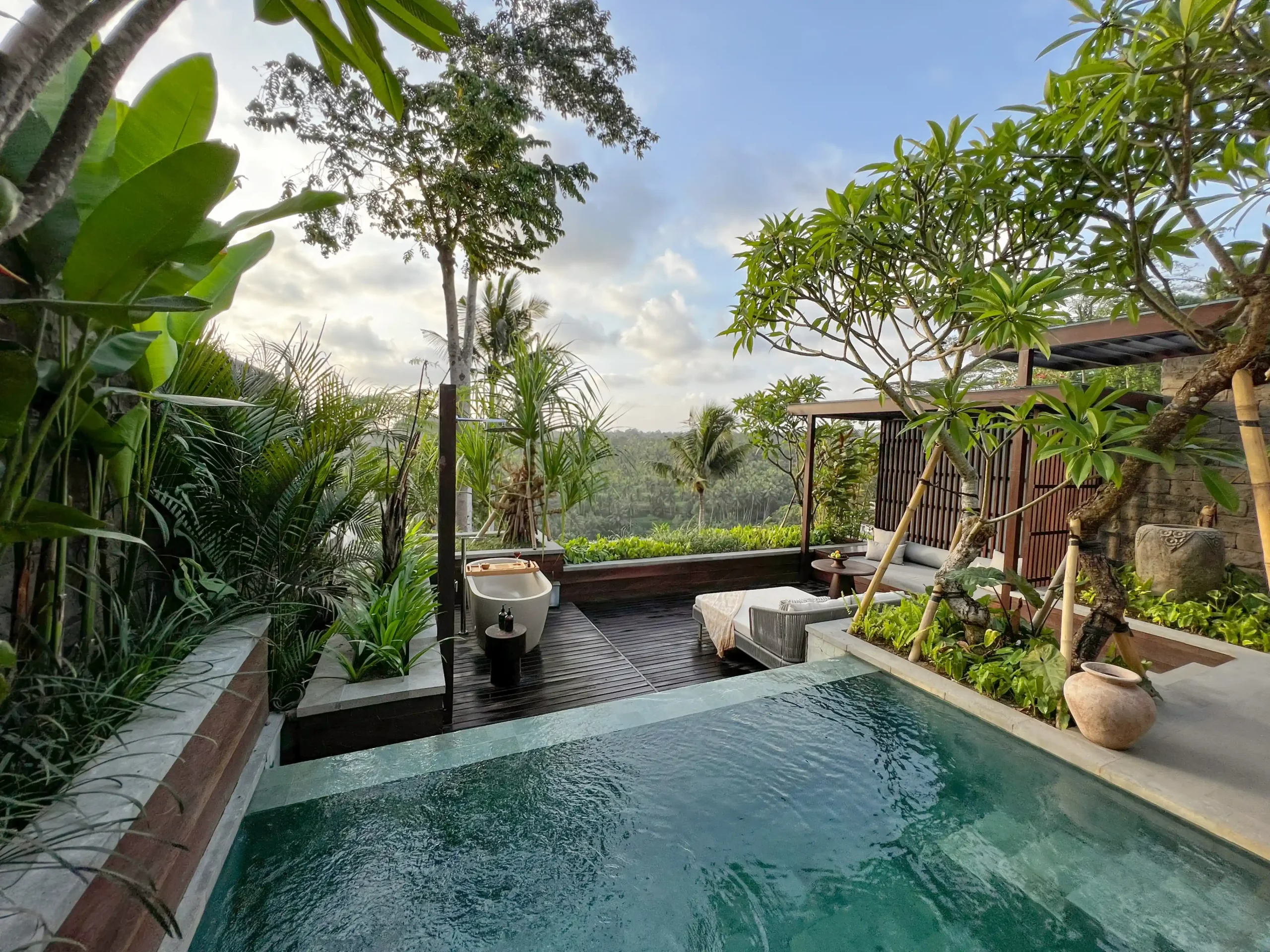 Private pool and outdoor bathtub on a lush terrace at The Ridge Bali with valley view and tropical plants