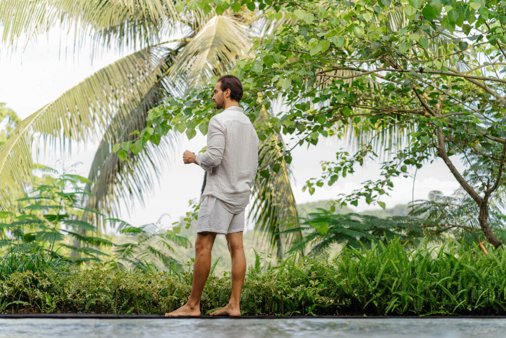 Man enjoying coffee with a jungle view at a Bali villa